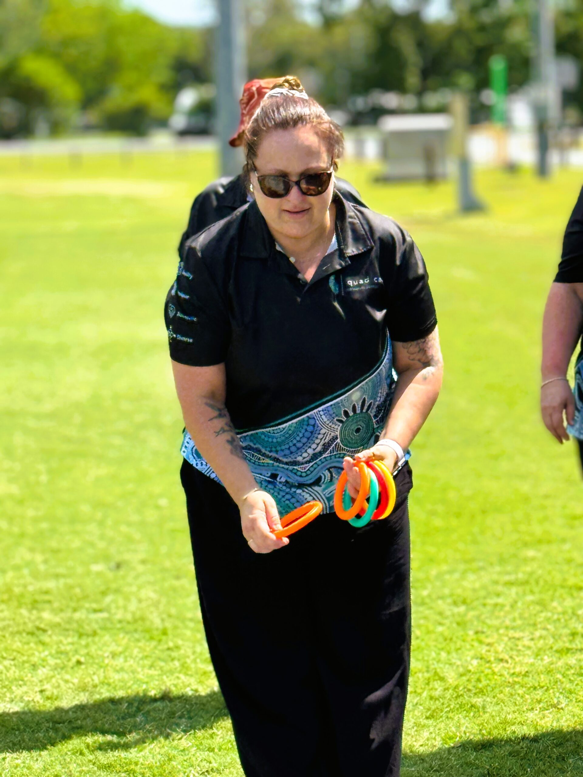 Allied Health Assistant at quad care throwing a hoop onto a peg