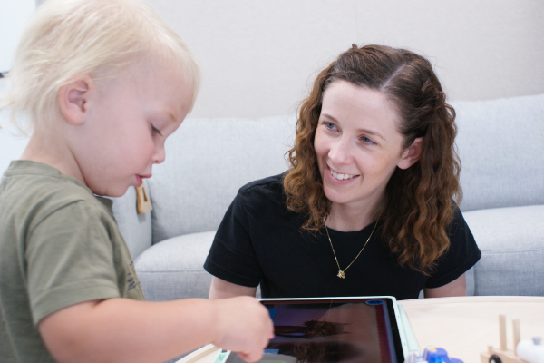 Speech Pathologist Emily chatting to a little boy Milo