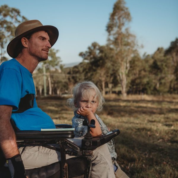 Quadriplegic man with his boy on a farm in woodford, queensland