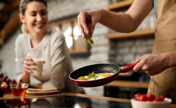 closeup-man-preparing-breakfast-his-girlfriend-n-kitchen