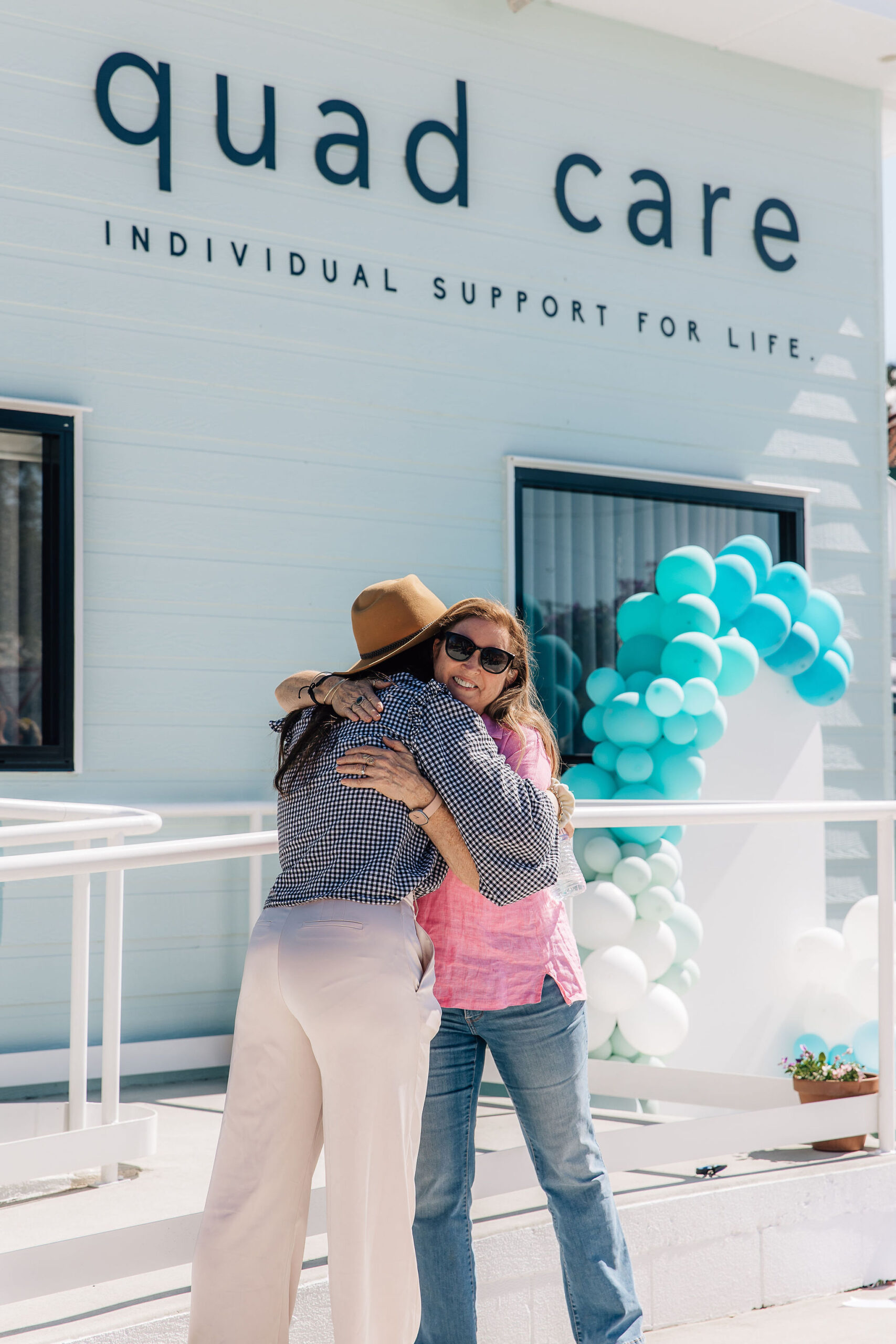 WQoodford Community Hub Opening Day, the owner hugging her mum at the front of the Quad Care office. 50 Archer St Woodford