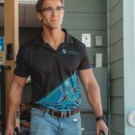 a man with a bag walking out the front door to his next client